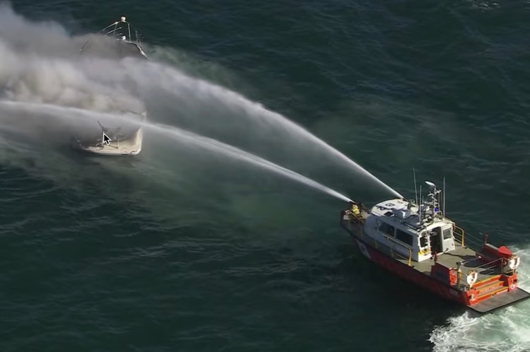 Two men survived their boat catching fire in Melbourne's Port Phillip Bay on Wednesday afternoon by jumping into the water before being plucked to safety.